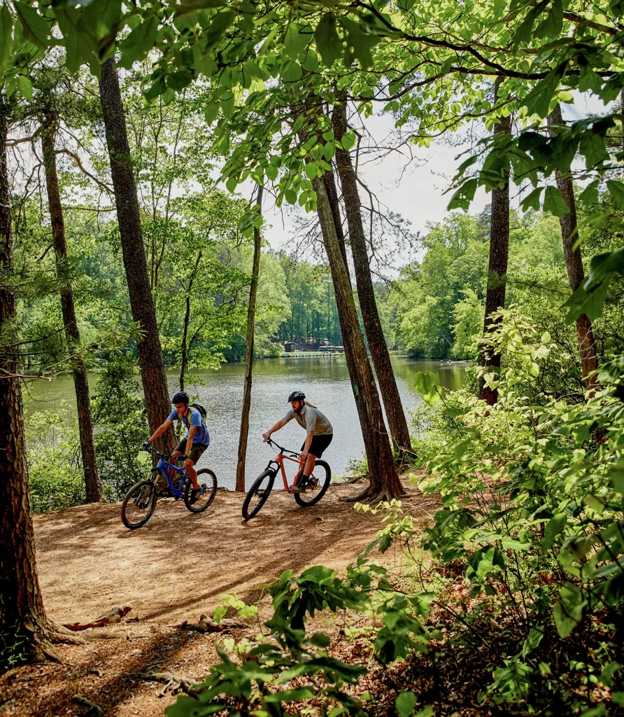 People on bikes in front of lake