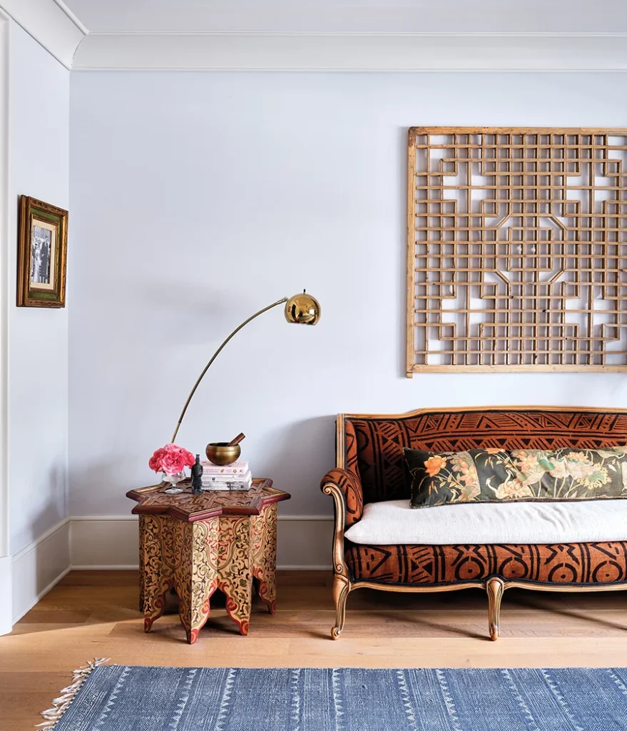 In the primary bedroom, Annie had her great-grandmother’s sofa recovered in a vintage mudcloth that she ordered from Europe. The fabric on the lumbar pillow came from chairs that belonged to her other grandmother.