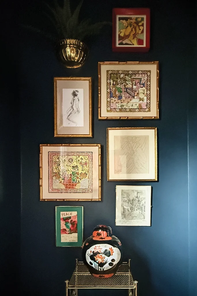 The powder room is filled with vintage art and accessories sourced from various flea markets and shops in Annie Totten's home