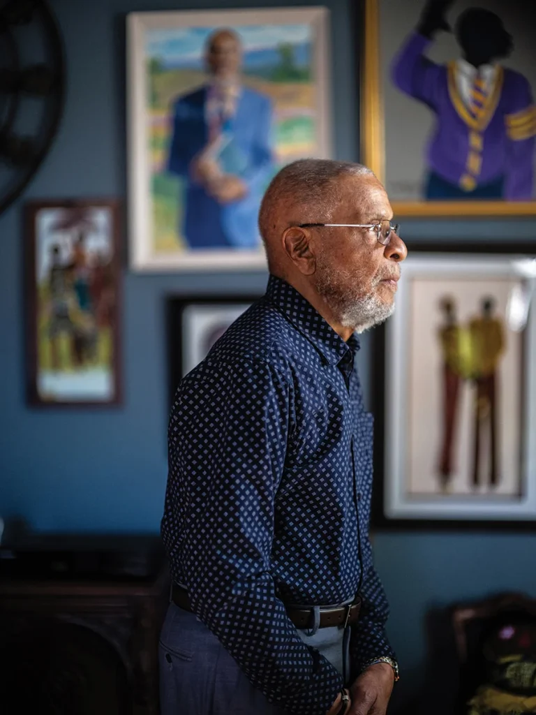 Portrait of Eddie Bell in front of artwork on wall