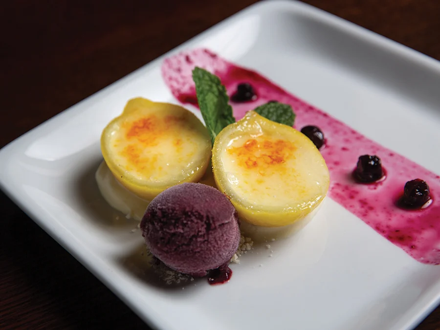 Bruleed lemon posset with blueberry compote, blueberry sorbet and lemon curd chantilly