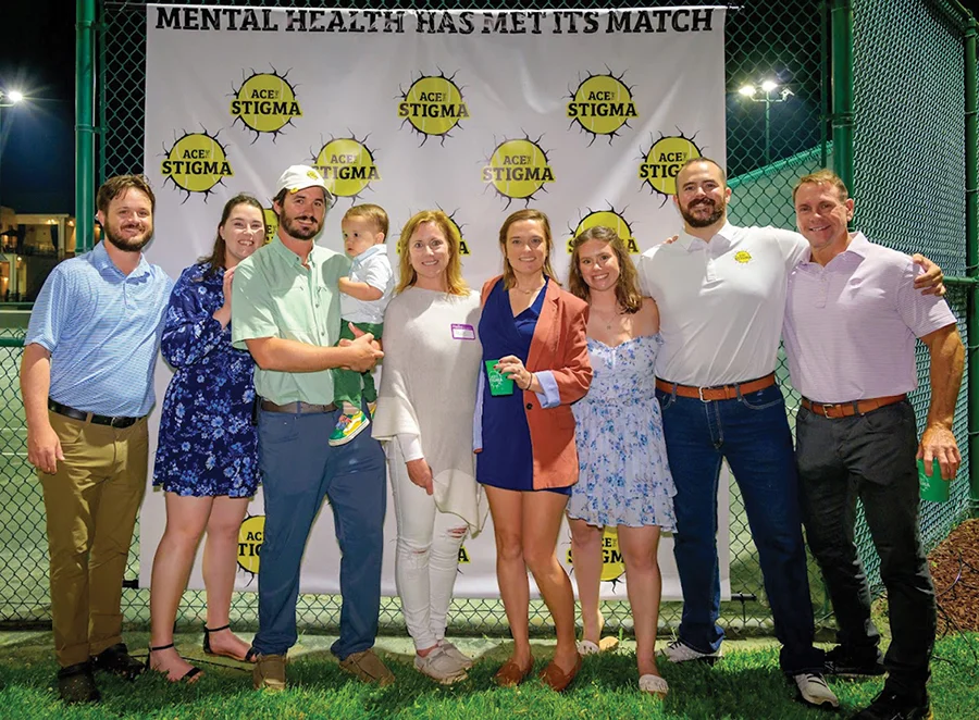 Supporters of Ace the Stigma stand together at their tennis event.