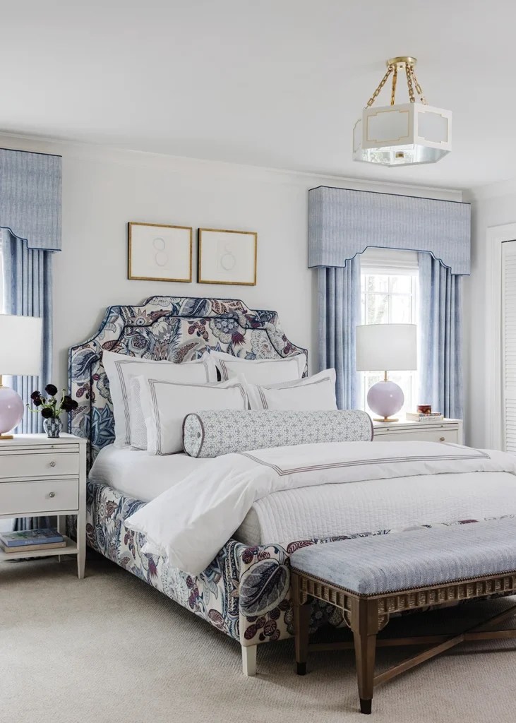 “Bright and happy” is how the homeowner describes her daughter’s bedroom. “We used a really bold Schumacher pattern on the bed as the base of the room,” Copeland says. After designing the custom bed, she repeated the design on custom cornice boards, which are covered in a light herringbone fabric. The Pindler fabric was also used for the draperies and on the upholstered bench. Lavender Visual Comfort lamps and a semi-flush-mount ceiling fixture from Colleen and Company add a finishing touch.