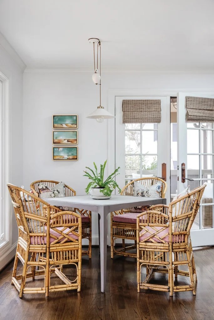 Vintage Brighton pavilion chairs surround a game table in the family room. Completing the vignette is a Hector Finch pendant, a trio of small landscape paintings and playful pillows with a chinoiserie design.
